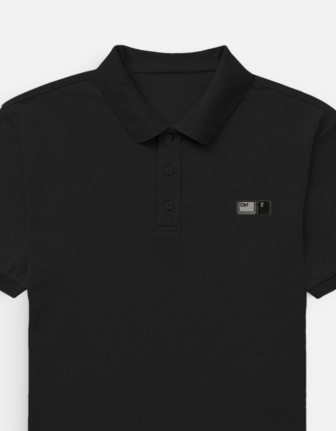 Front view of a premium heavyweight boxy pitch black waffle knit polo shirt featuring minimalist matte black tonal embroidery on the left chest by CTRL Z