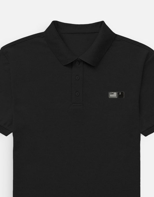Front view of a premium heavyweight boxy pitch black waffle knit polo shirt featuring minimalist matte black tonal embroidery on the left chest by CTRL Z