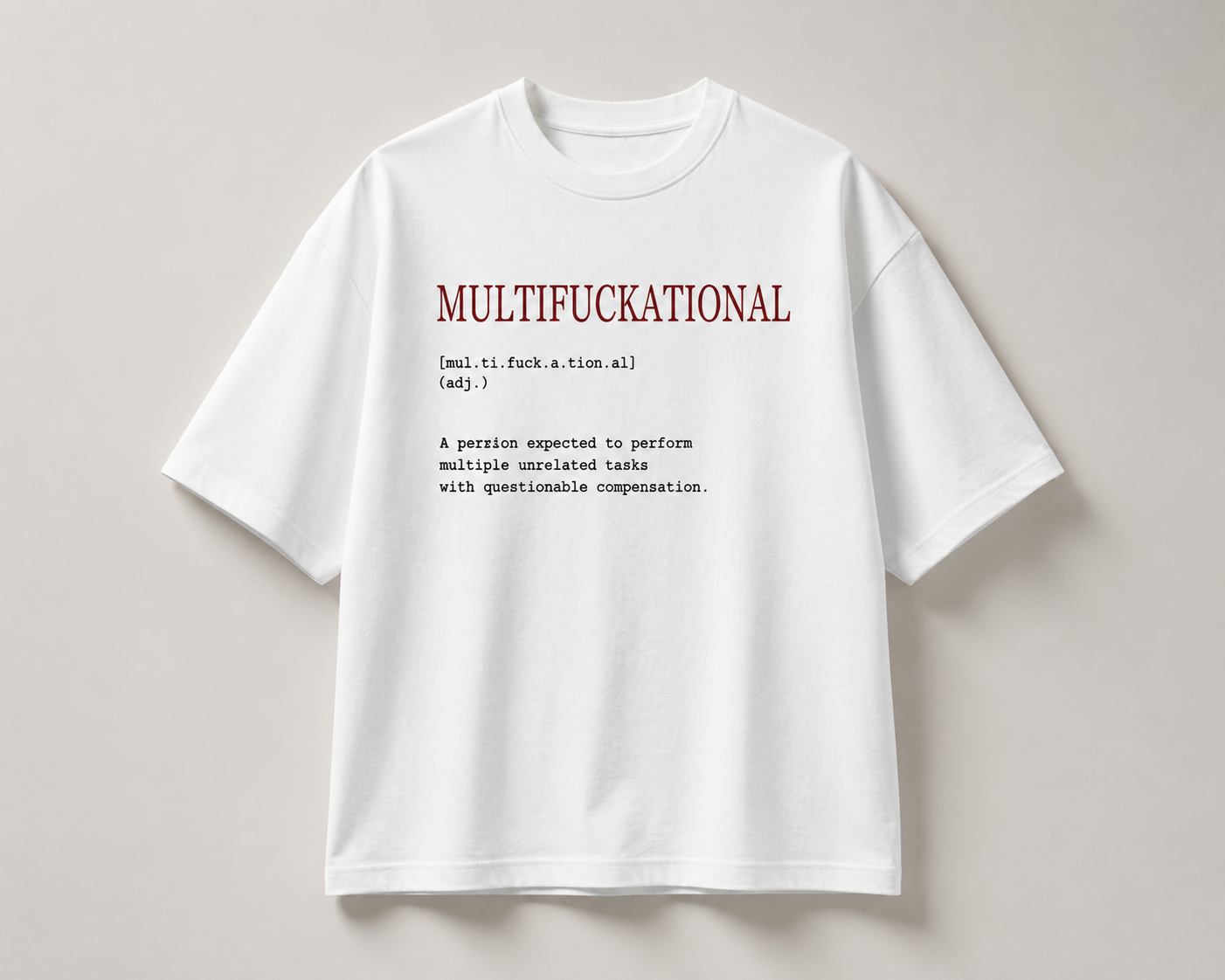 A white short-sleeve t-shirt with a humorous dictionary-style definition printed on the chest, displayed flat against a neutral light gray background.