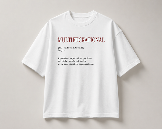 A white short-sleeve t-shirt with a humorous dictionary-style definition printed on the chest, displayed flat against a neutral light gray background.